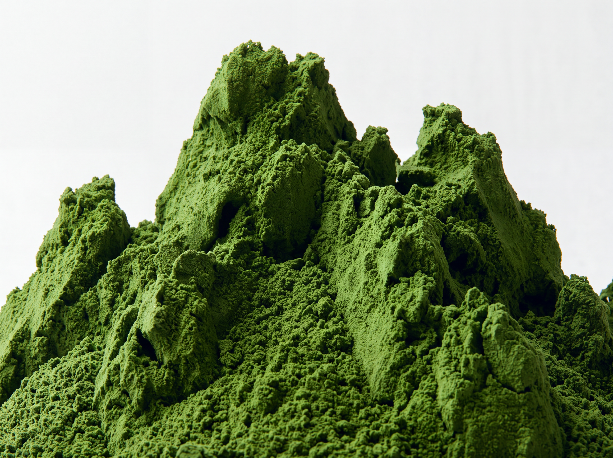 A close-up of matcha powder against a plain light background.
